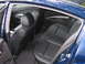 2005 Nissan Maxima - Rear interior view of a blue 2005 Nissan Maxima, showing black leather seats and door panels.