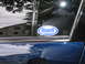 2005 Nissan Maxima - Car window shows a Buell sticker and some text, with a reflection of the photographer.