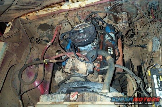 Engine bay of a 1978 Dodge Power Ram, showing the V8 engine, radiator, battery, and various hoses and wires
