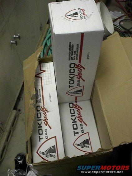 Cardboard box with Tokico gas shocks, some torn