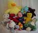 1981 Ford Bronco - A baby is surrounded by a collection of stuffed animals, including a large yellow duck and several teddy bears.