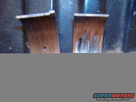 Two worn engine bearings with copper showing through the bearing surface