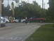1991 Ford Probe - Several vehicles and people are gathered at a street intersection.