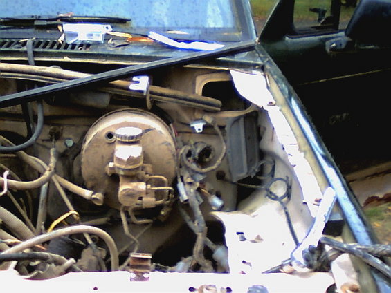 Engine bay view of brake booster and master cylinder