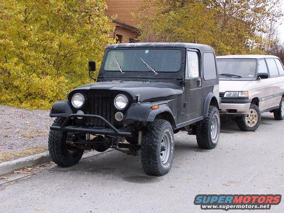 Black 1983 Jeep CJ7 3/4 front view parked on street