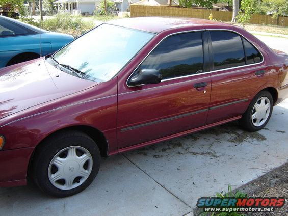 Maroon sedan, side view, showing tinted windows and silver hubcaps