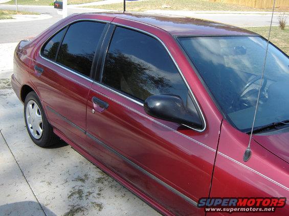 Red 1998 Nissan Sentra sedan, driver's side, 3/4 front view, tinted windows, chrome trim, alloy wheels