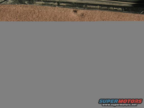 tan carpet and black trim inside a vehicle