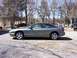 1996 Ford Probe - A gray Ford Probe coupe is parked on a gravel lot with trees in the background.