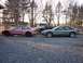 1996 Ford Probe - Two Ford Probes and a pickup truck are parked on a gravel lot with trees in the background.