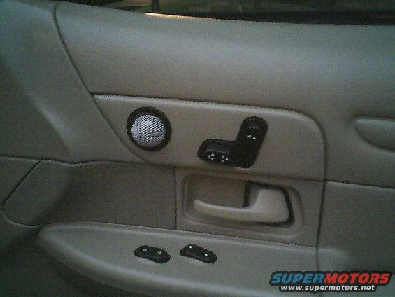 1999 Ford Crown Victoria interior door panel showing speaker grille and power seat controls