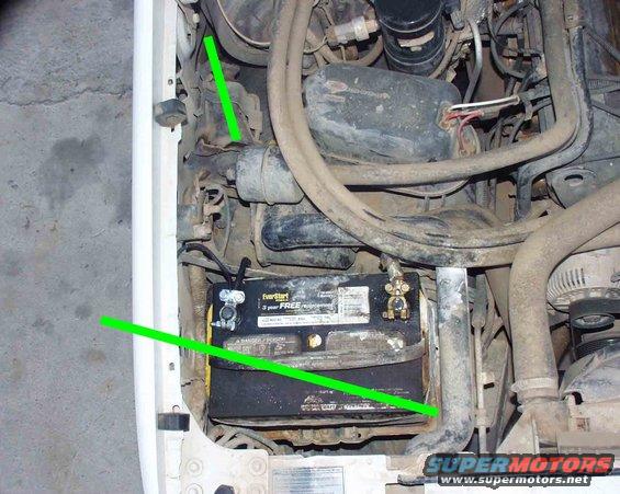 Engine bay showing a dirty EverStart battery and various hoses and wires