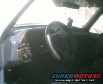 Interior view of a car dashboard with steering wheel and vents