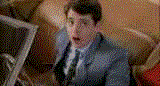 Guy in a suit looking shocked, surrounded by tan, fuzzy objects