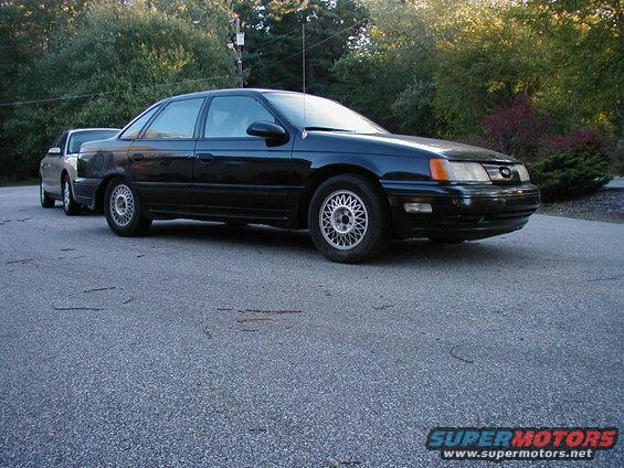 Black 1990 Ford Taurus sedan, 3/4 front view