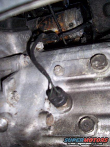 close-up of engine part with wires and bolts