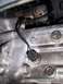 1991 Ford Probe - This is a close-up view of a component within a vehicle's engine bay, showing wiring and metal parts.