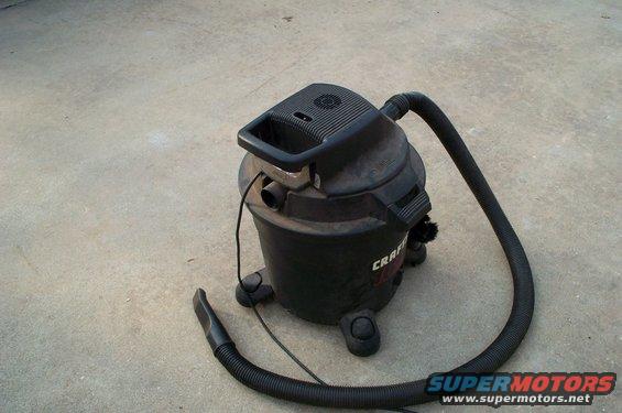 Craftsman shop vacuum with hose and nozzle on concrete