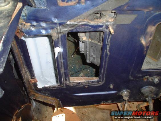 Blue vehicle interior structure with open cavities and visible rust