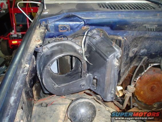 HVAC blower motor housing removed from vehicle interior