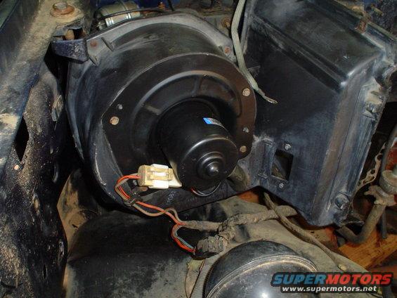 HVAC blower motor assembly with wiring harness, viewed from engine bay