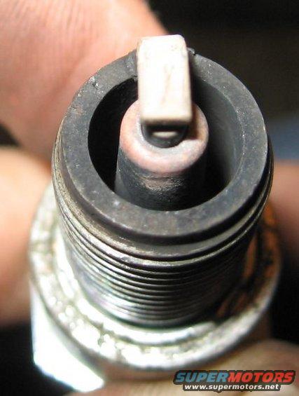 Spark plug with worn electrode and ceramic insulator