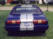 1977 Ford Mustang II - The rear of a blue 1977 Ford Mustang II, silver racing stripes and a Tennessee license plate.