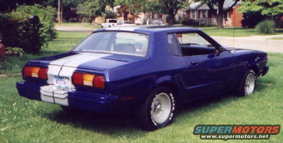 Blue 1977 Ford Mustang II coupe with white racing stripes, rear 3/4 view