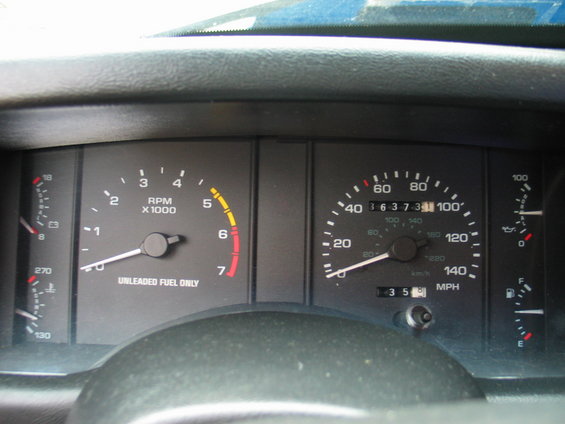 1990 Ford Mustang dashboard with tachometer, speedometer, odometer, fuel gauge, and temperature gauge