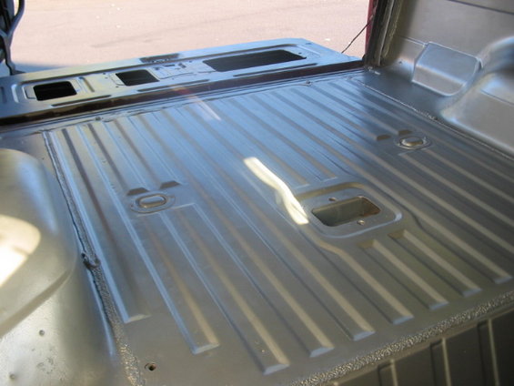 Truck bed interior with ribbed floor and tie-down points