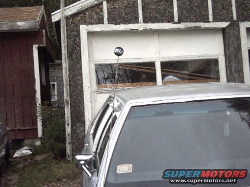Silver 1991 Ford Crown Victoria LTD with a black antenna ball, seen from the front