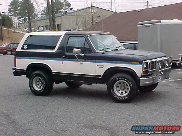 Blue and white 1985 Ford Bronco 3/4 front view