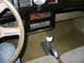 1985 Ford Crown Victoria LTD - The interior of a car features a steering wheel, a dashboard with custom switches, and a floor-mounted shifter.