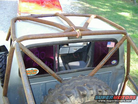 Roll cage on a truck with purple tinted rear window showing interior