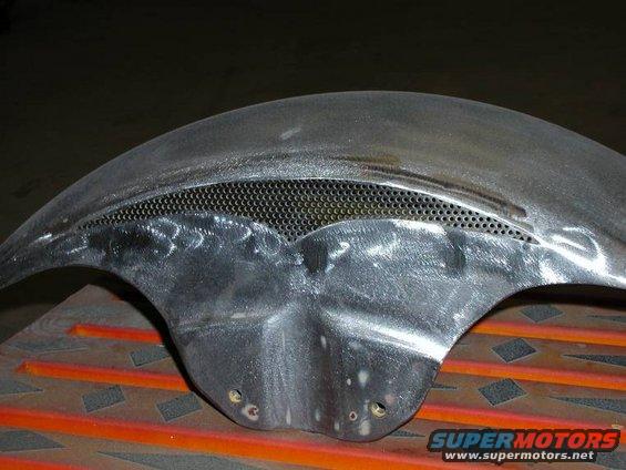 Bare metal motorcycle fender with a perforated section