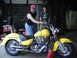 1998 Suzuki VL 1500 Intruder Classic - Two men stand in a garage with a bright yellow cruiser motorcycle.