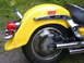 1998 Suzuki VL 1500 Intruder Classic - A yellow motorcycle's rear fender, wheel, and exhaust pipes are visible in this close-up shot.