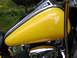 1998 Suzuki VL 1500 Intruder Classic - Close-up of a bright yellow motorcycle fuel tank with polished chrome details.