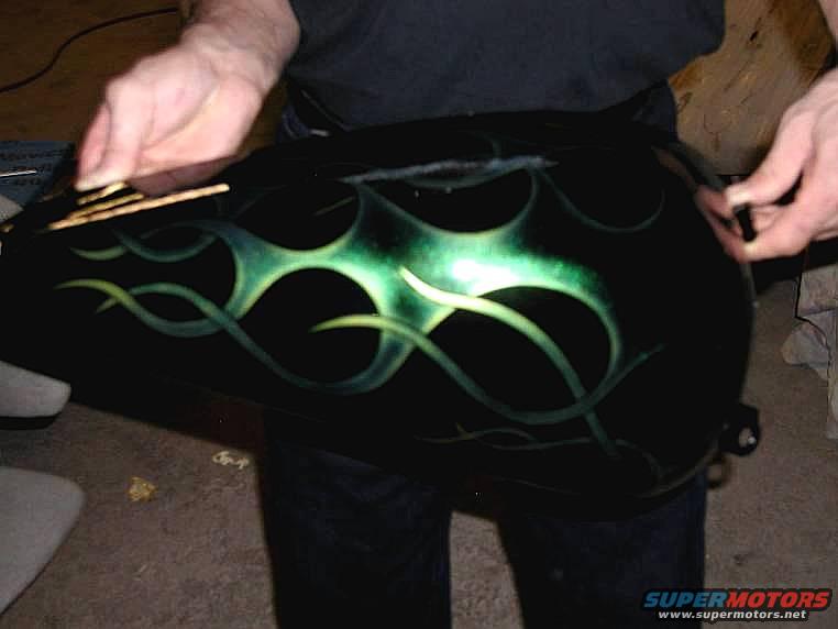 Black motorcycle gas tank with custom green flame paint