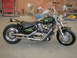 1998 Suzuki VL 1500 Intruder Classic - A custom motorcycle with a striking flame paint design sits in a workshop.
