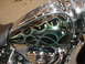 1998 Suzuki VL 1500 Intruder Classic - Close-up of a motorcycle's fuel tank custom green and black flame graphics with a metallic finish.