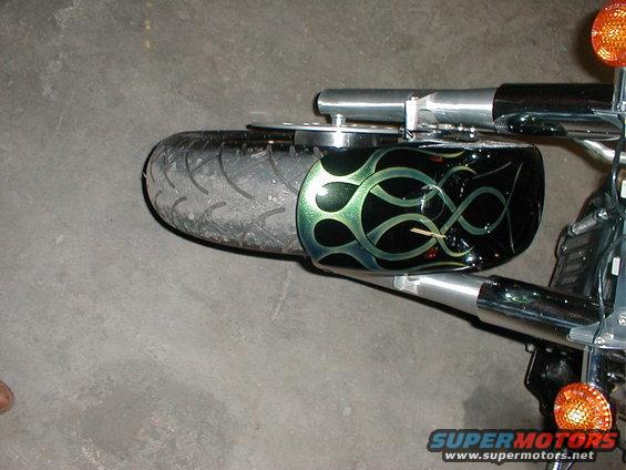 Motorcycle front wheel and fender with green flame graphics. Supermotors.net logo visible