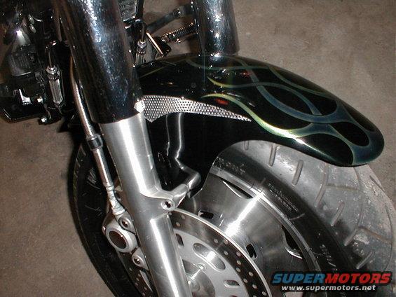 Black motorcycle fender with green and blue flame graphics and chrome accents