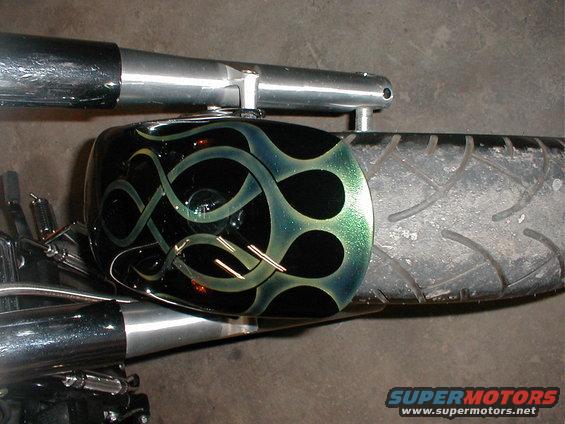 Motorcycle fender with black and green flame paint job and chrome exhaust pipe