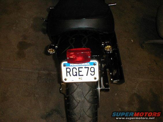 Motorcycle rear fender with Pennsylvania license plate RGE 79, red taillight, and black seat