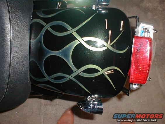 Motorcycle rear fender with green and silver flame graphics. Includes red taillight and chrome accents