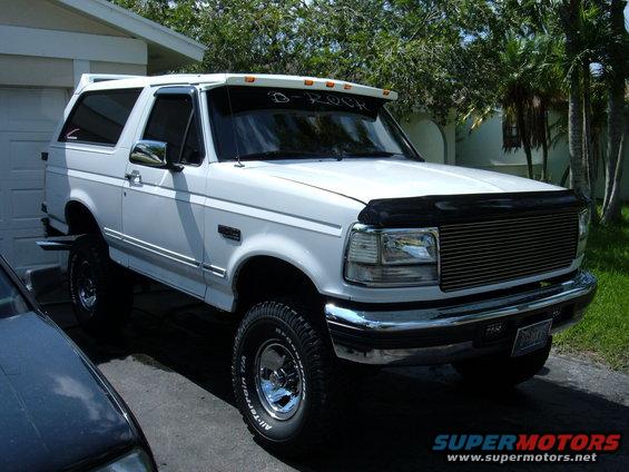 White 1995 Ford Bronco with chrome grille and visor reading 'D-ROCK'