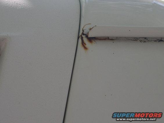 rust spot same on both sides up by drip rail above door