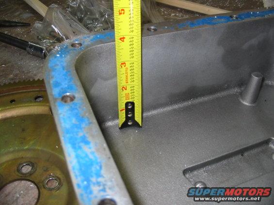 Measuring tape inside an engine oil pan