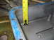 1997 Ford Crown Victoria - A yellow measuring tape is placed inside a metal engine oil pan, showing its depth.